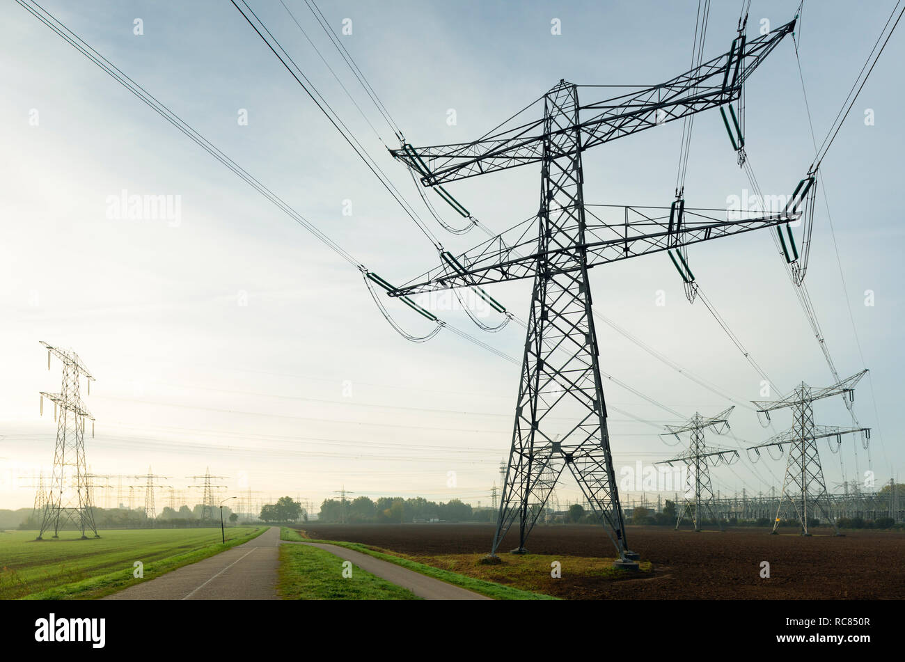 Field landscape with power lines near coal fired power station, Netherlands Stock Photo