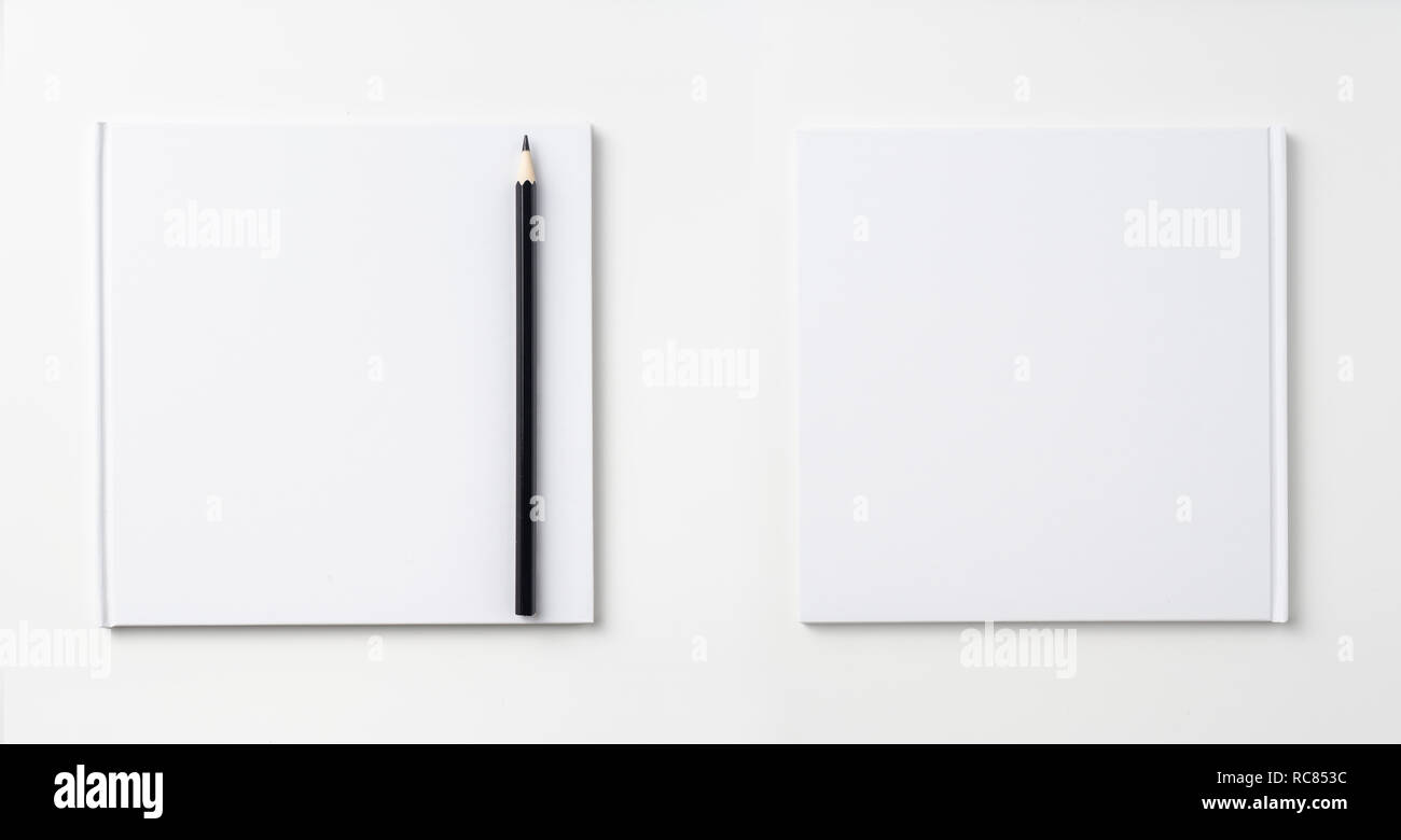 Design concept - Top view of pure white notebook, white page and pencil isolated on background for mockup Stock Photo