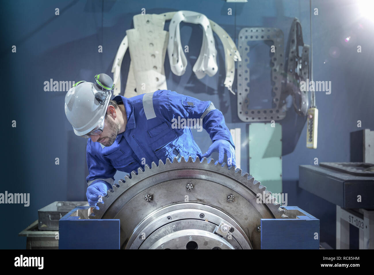 Engineer inspecting large gear during outage in nuclear power station Stock Photo