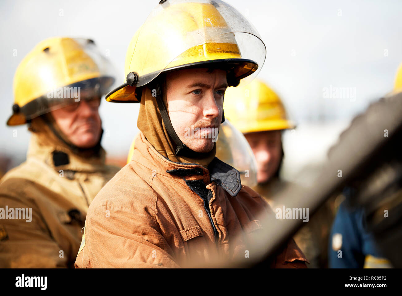 Firemen training, small group of firemen listening to instructions Stock Photo