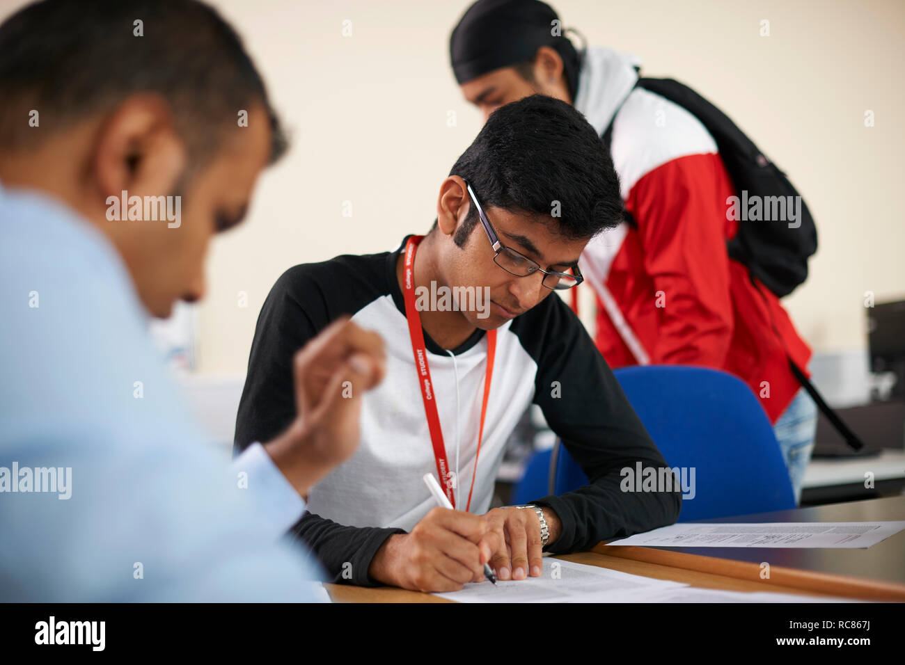 Lecturer talking to college students in classroom Stock Photo