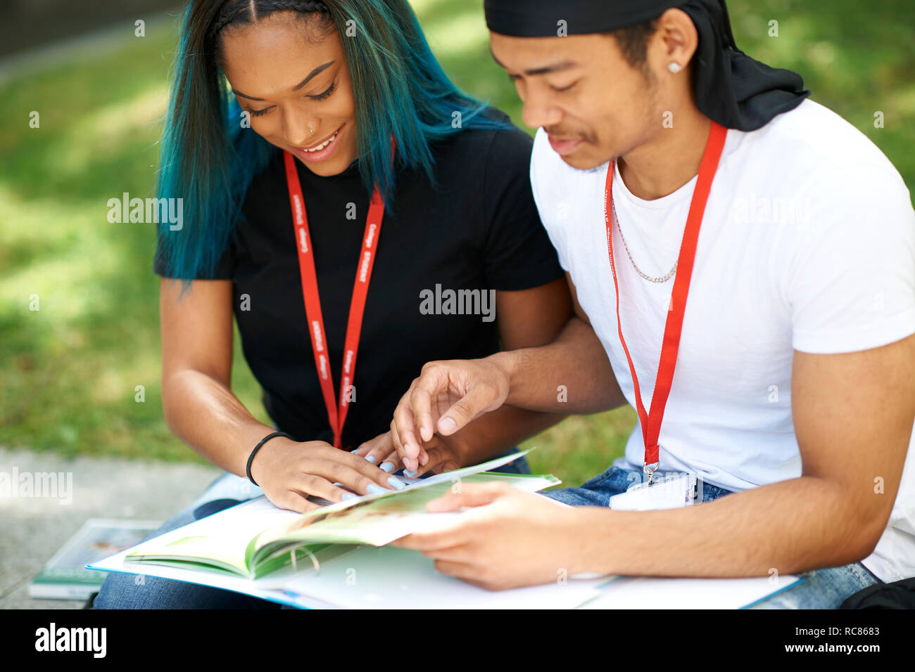 College students reading and talking in campus Stock Photo