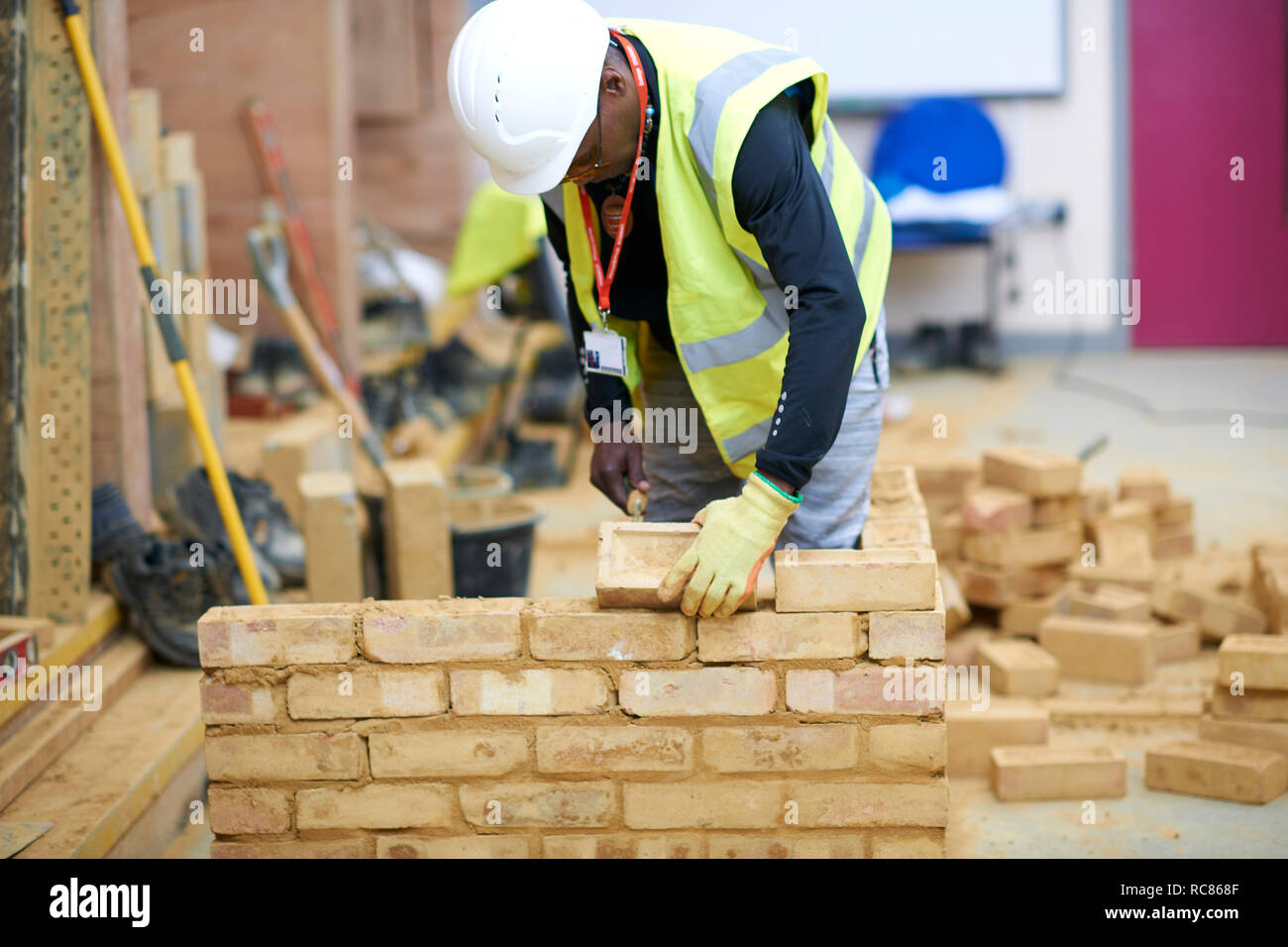 Lecturer building brick wall in classroom Stock Photo
