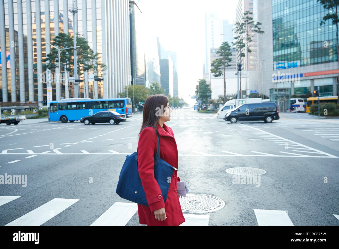 Businesswoman on pedestrian crossing in city, Seoul, South Korea Stock Photo