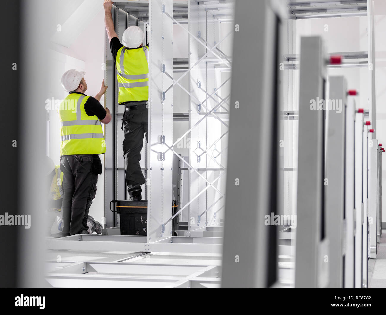 Men putting up metal structure Stock Photo