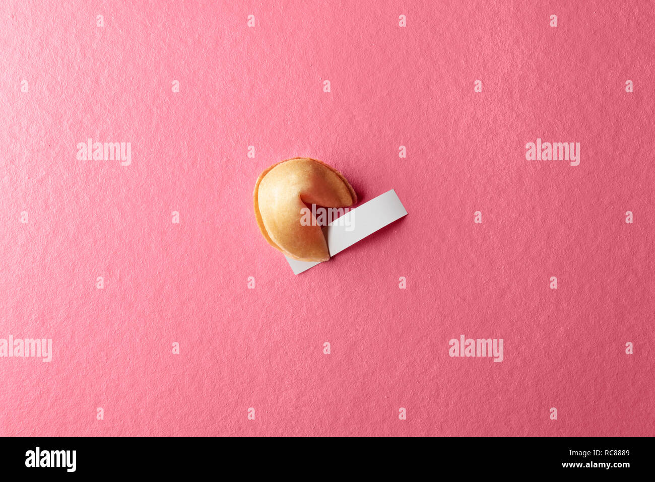 Fortune cookie with blank paper on the pink background Stock Photo - Alamy