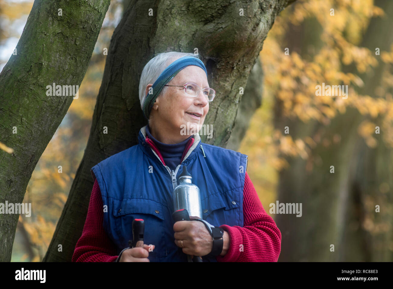 Senior woman resting from walk in park Stock Photo