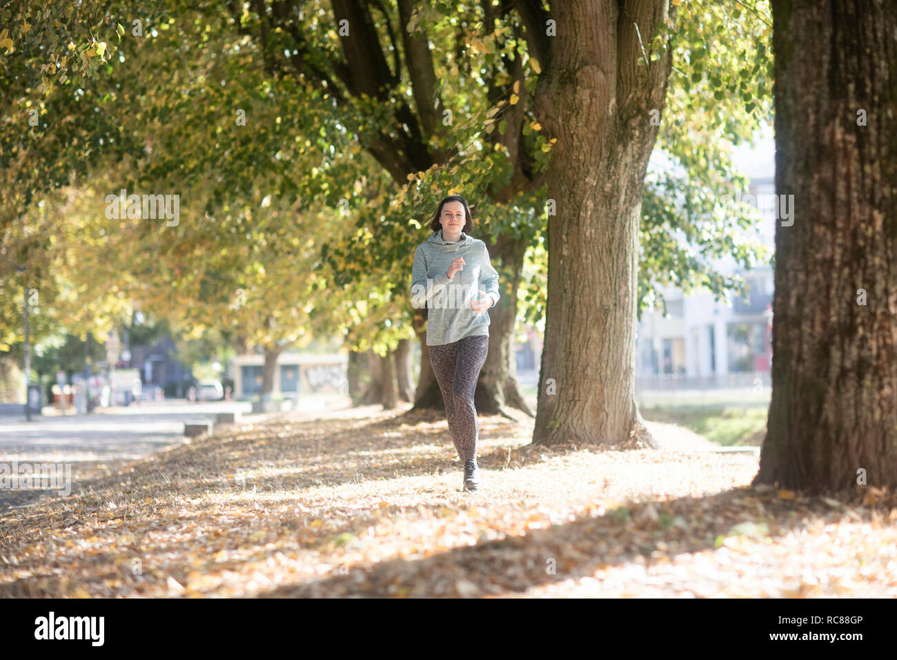 Cross country jogger running in park Stock Photo