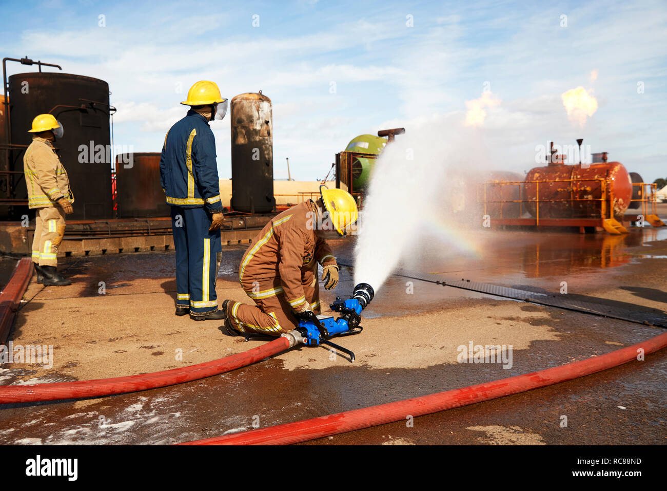Firemen training to put out fire on burning tanks hires stock