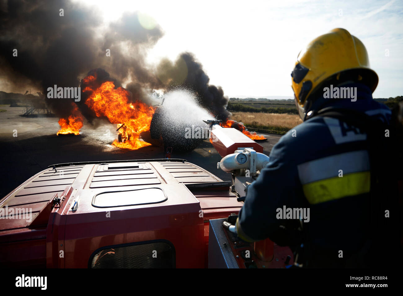 Fireman putting out fire on old training aeroplane, Darlington, UK Stock Photo