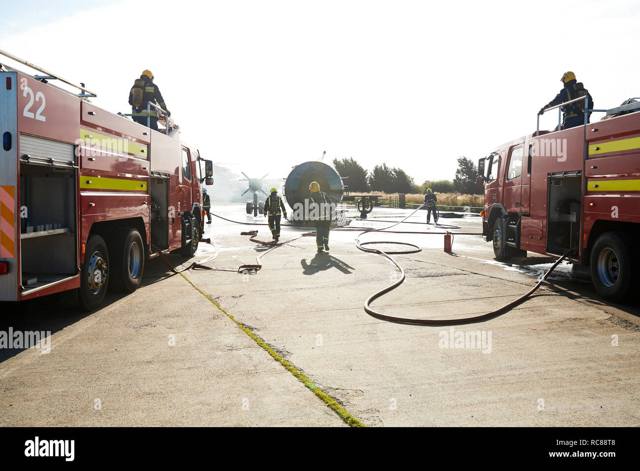 Firemen putting out fire on old training aeroplane, Darlington, UK Stock Photo