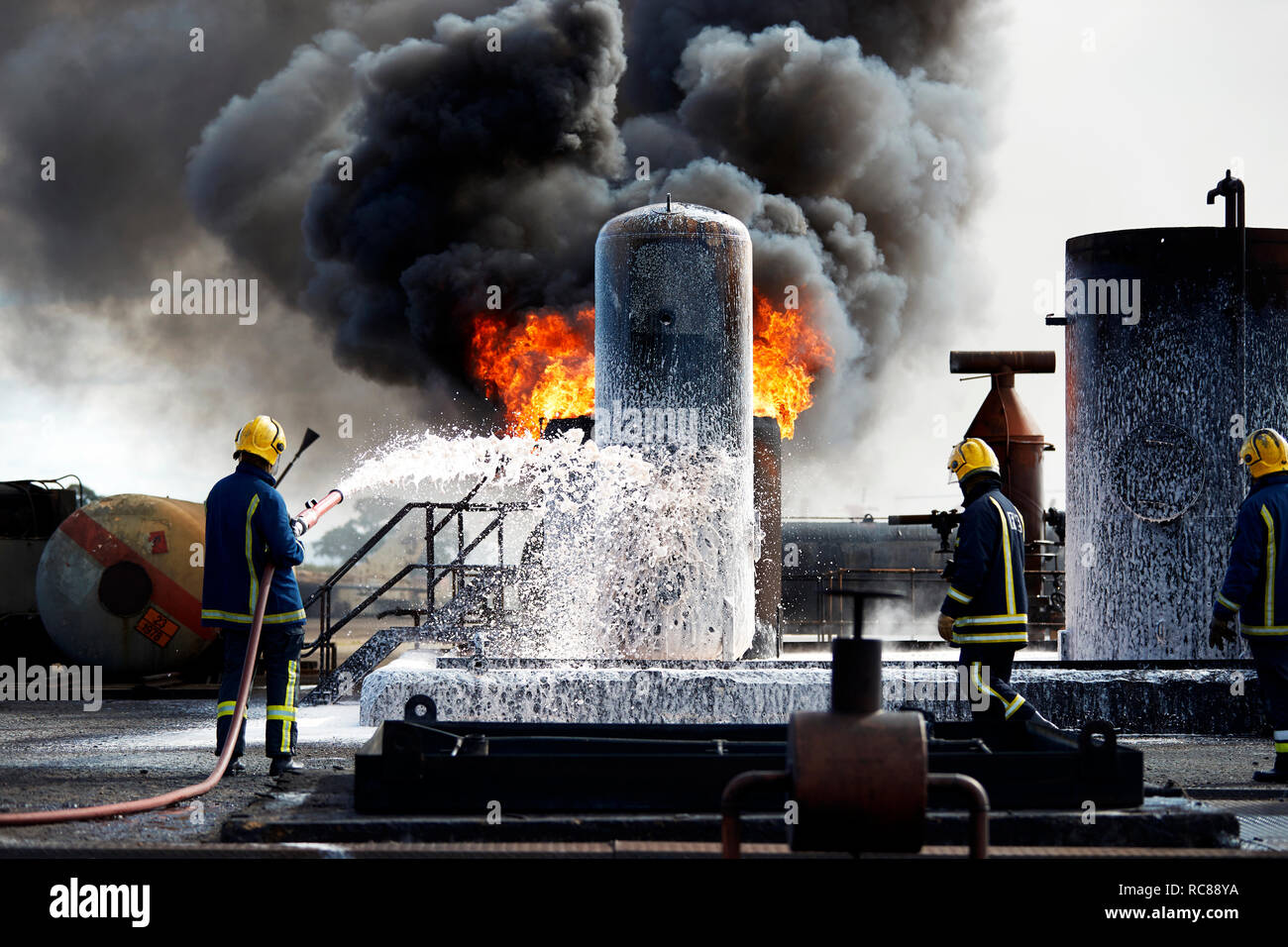 Firemen training to put out fire on burning tanks, Darlington, UK Stock Photo