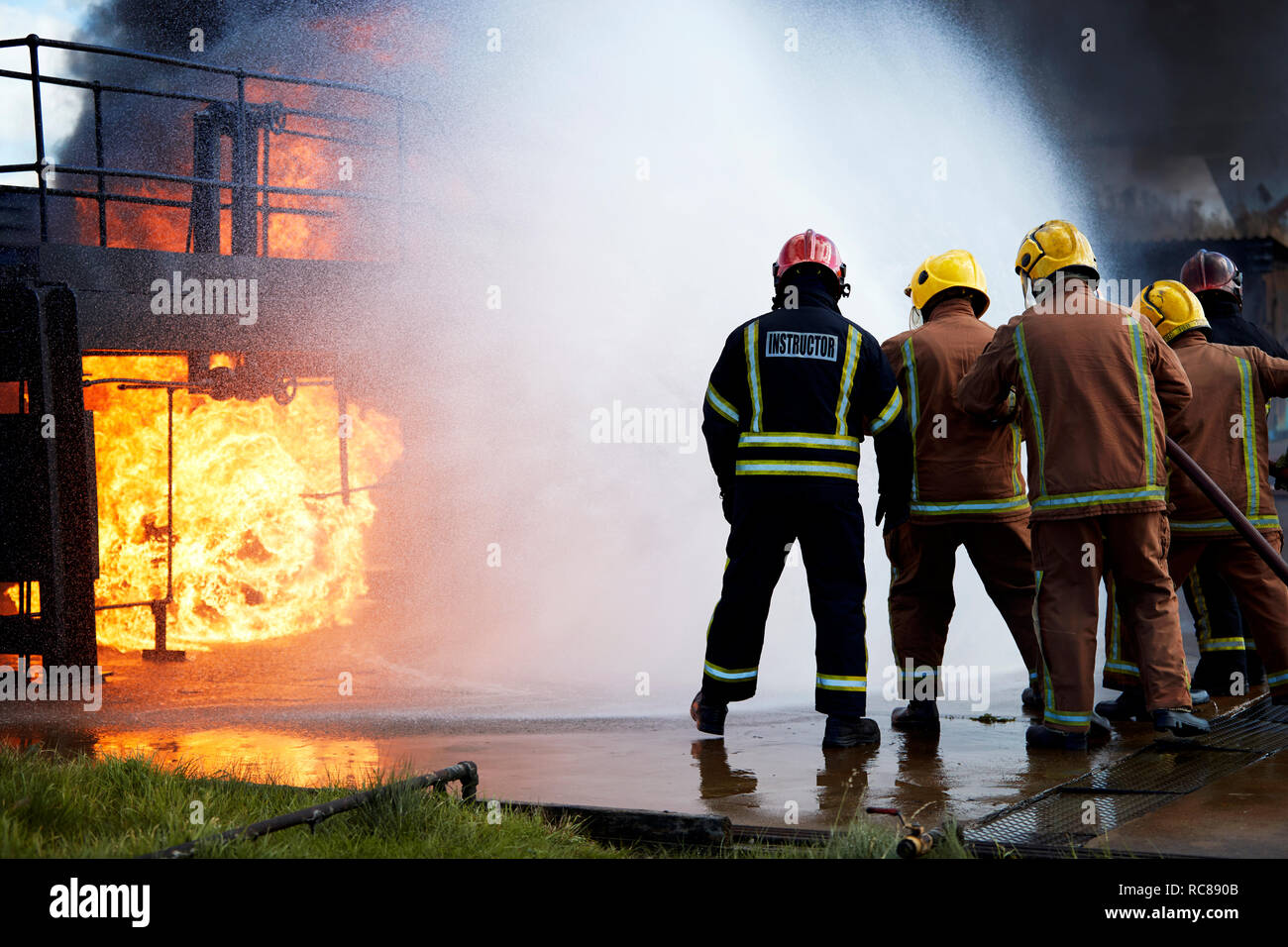 Firemen training to put out fire on burning building, Darlington, UK Stock Photo