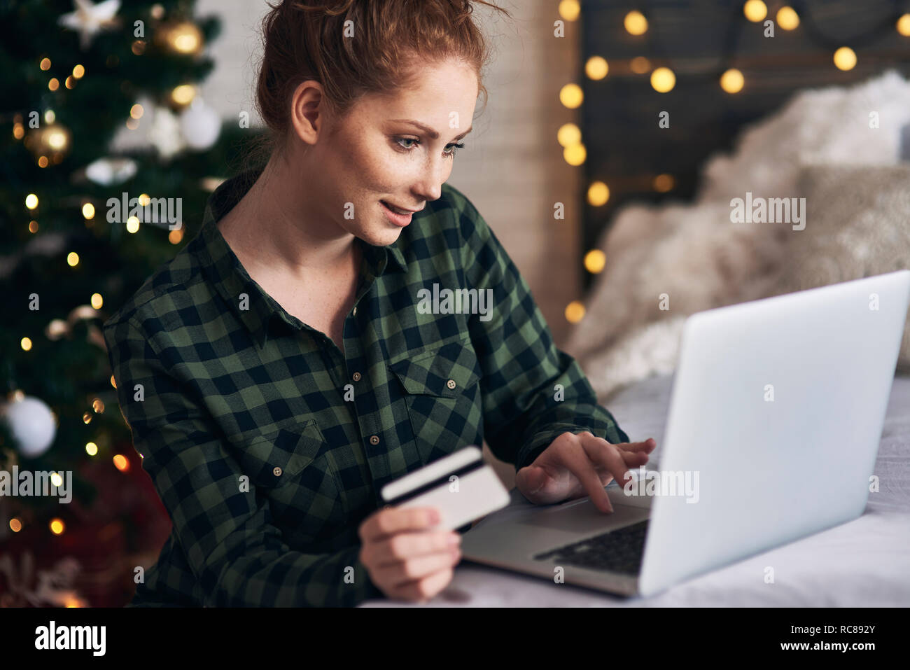 Woman shopping for Christmas presents online Stock Photo