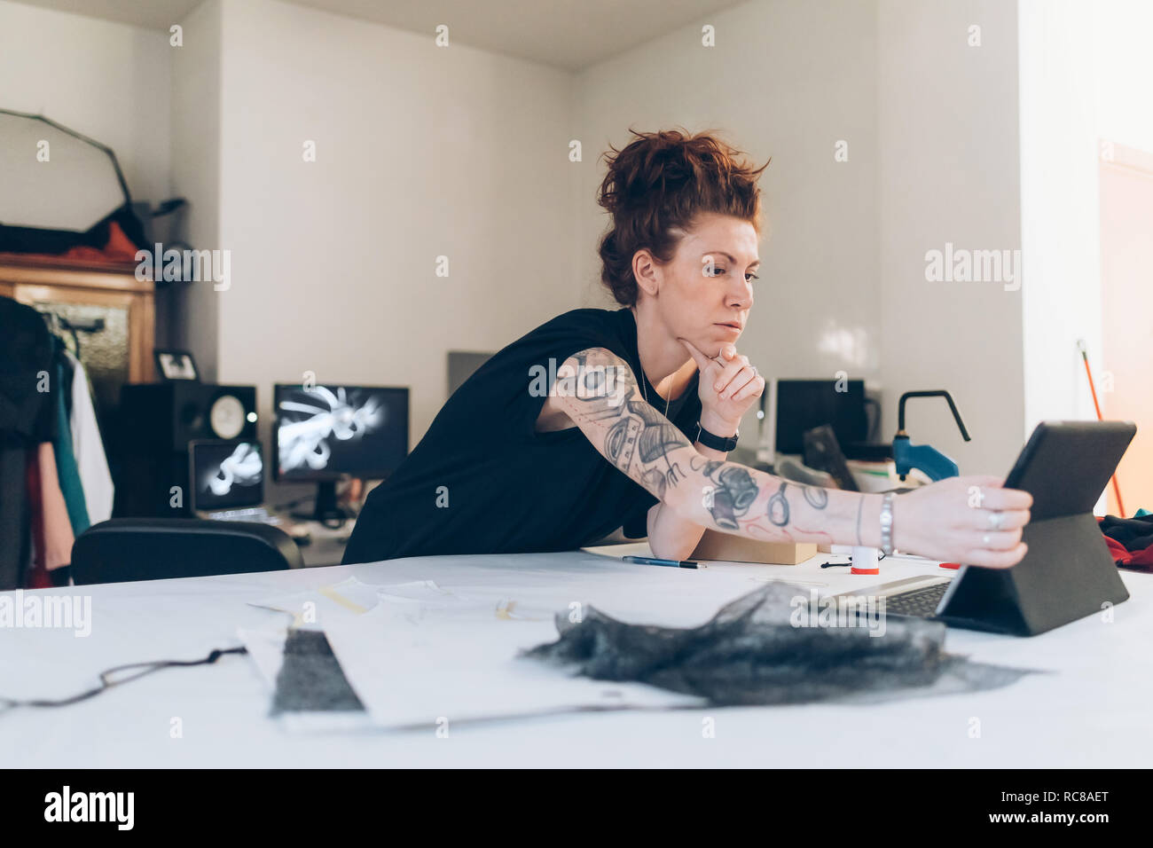 Fashion designer researching using digital tablet Stock Photo