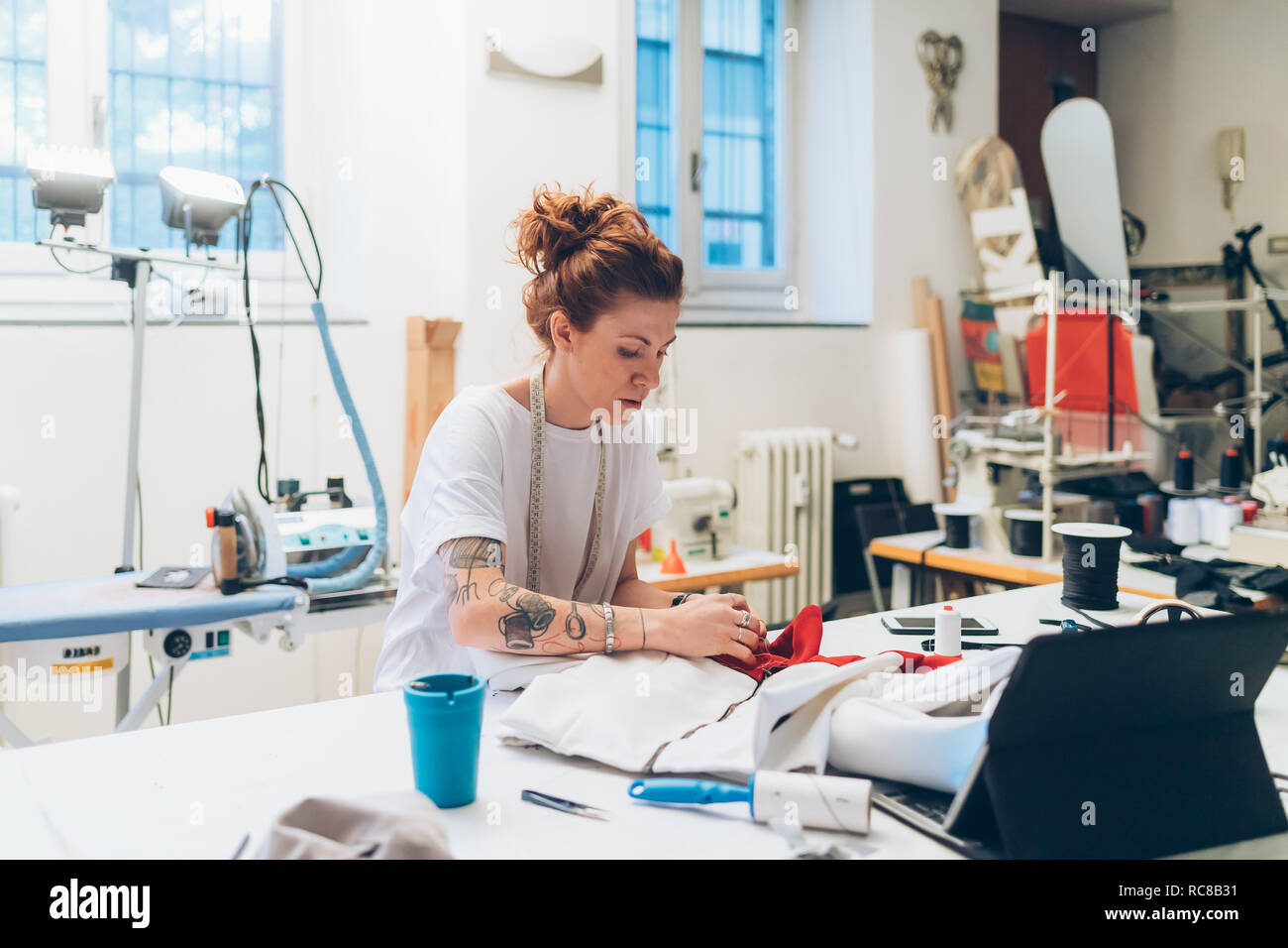 Fashion designer working in her studio Stock Photo - Alamy