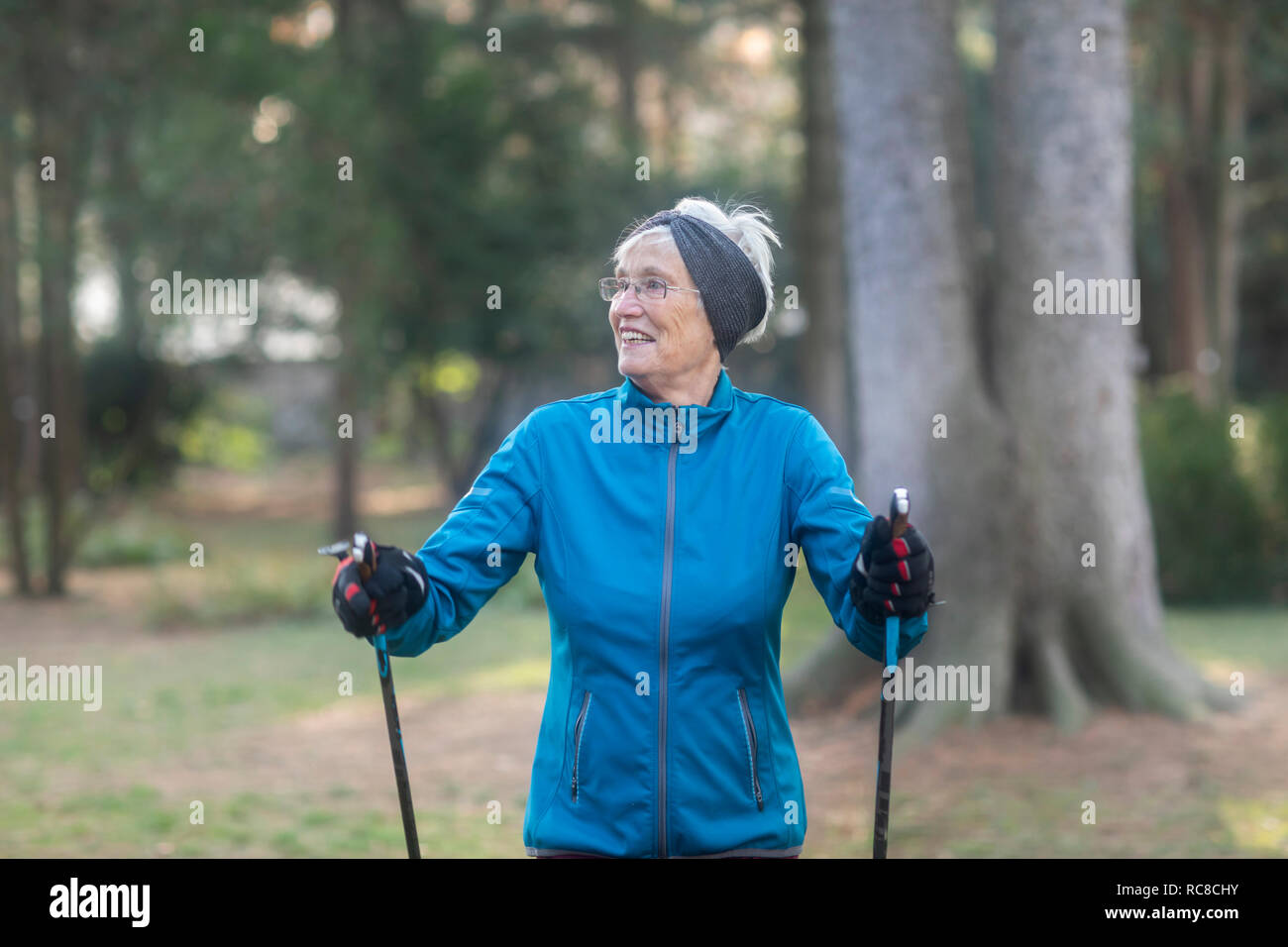 Senior woman nordic walking in park Stock Photo
