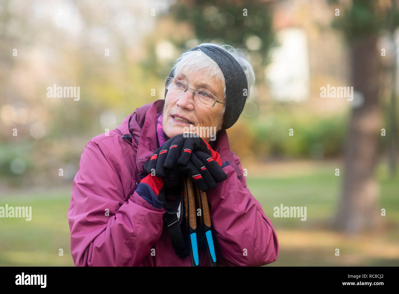 Senior woman resting from walk in park Stock Photo