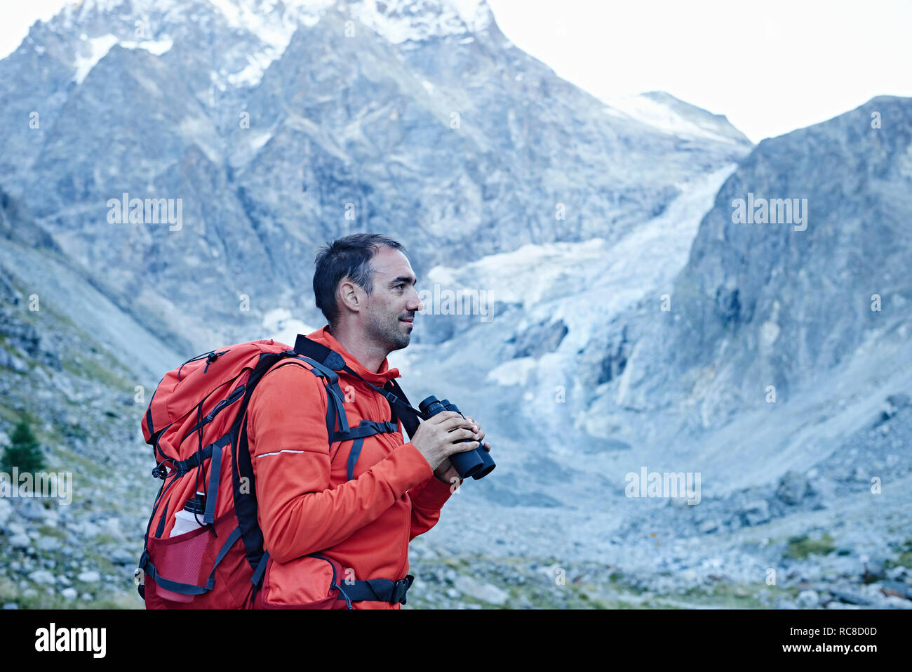Hiker using binoculars, Mont Cervin, Matterhorn, Valais, Switzerland Stock Photo
