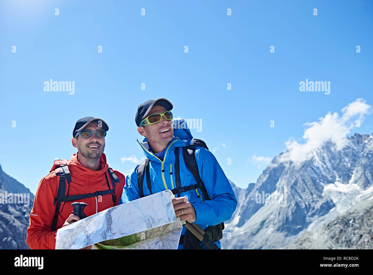 Hiker friends reading map, Mont Cervin, Matterhorn, Valais, Switzerland Stock Photo