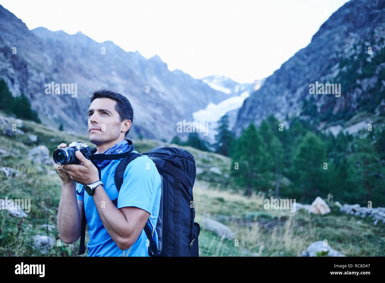 Hiker taking photograph, Mont Cervin, Matterhorn, Valais, Switzerland Stock Photo