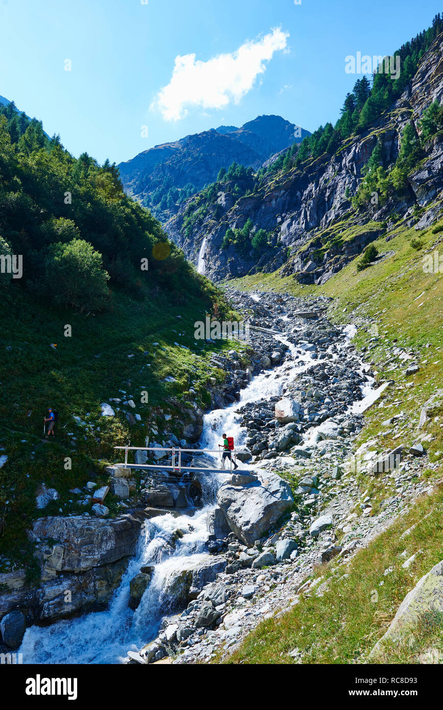 Hiker crossing narrow bridge, Mont Cervin, Matterhorn, Valais, Switzerland Stock Photo
