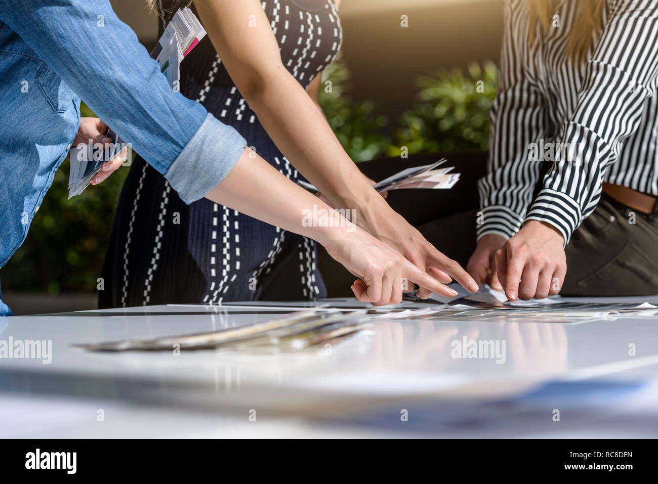 Colleagues brainstorming with colour charts Stock Photo