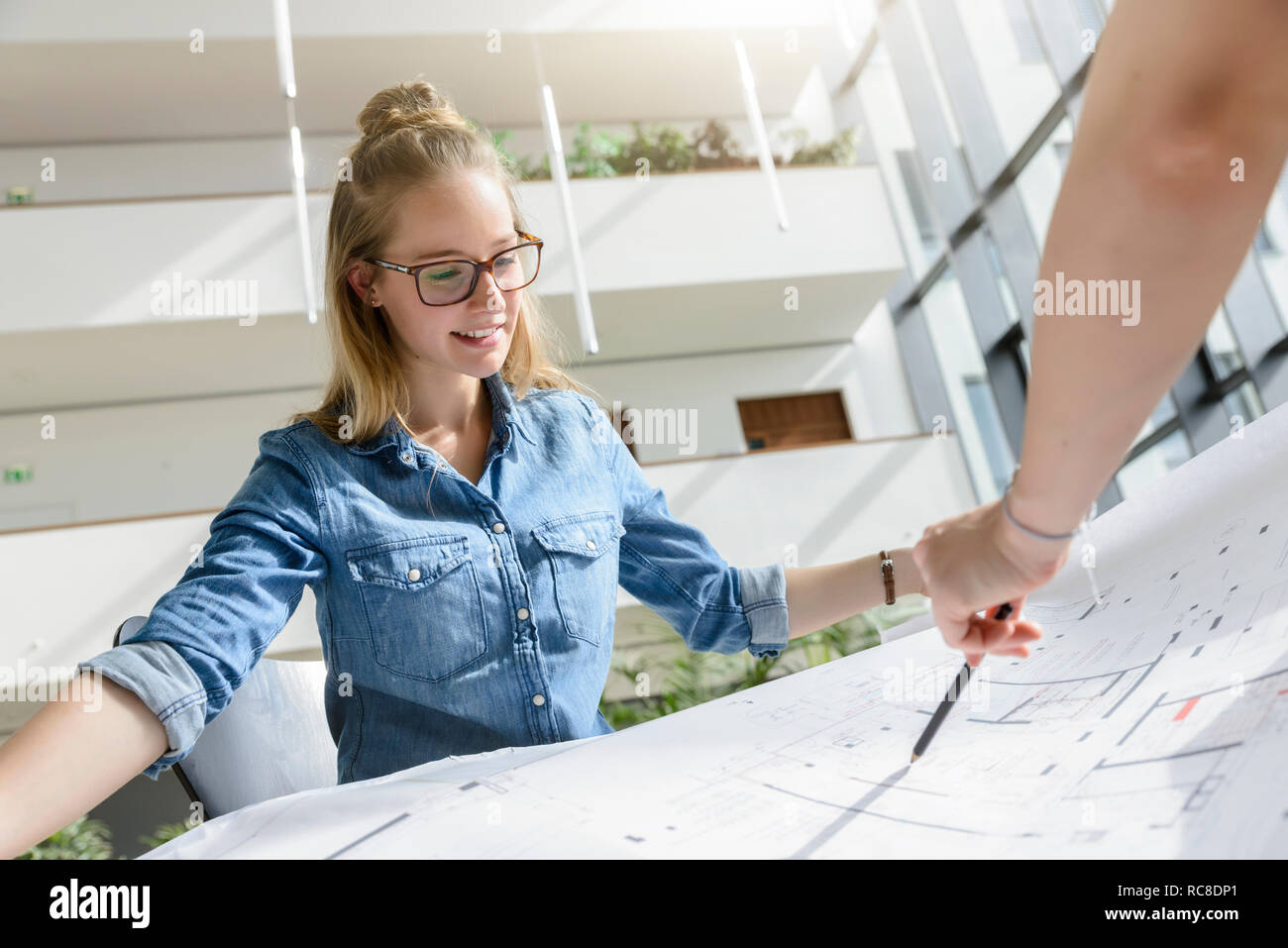 Colleagues brainstorming over charts in bright sunlight Stock Photo