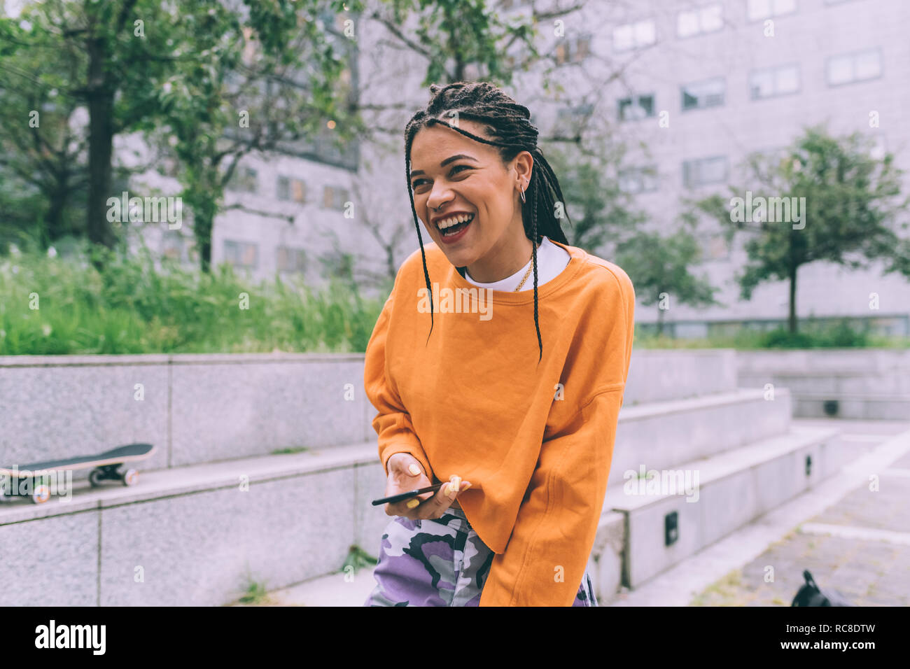 Laughing woman wearing orange hi-res stock photography and images - Alamy