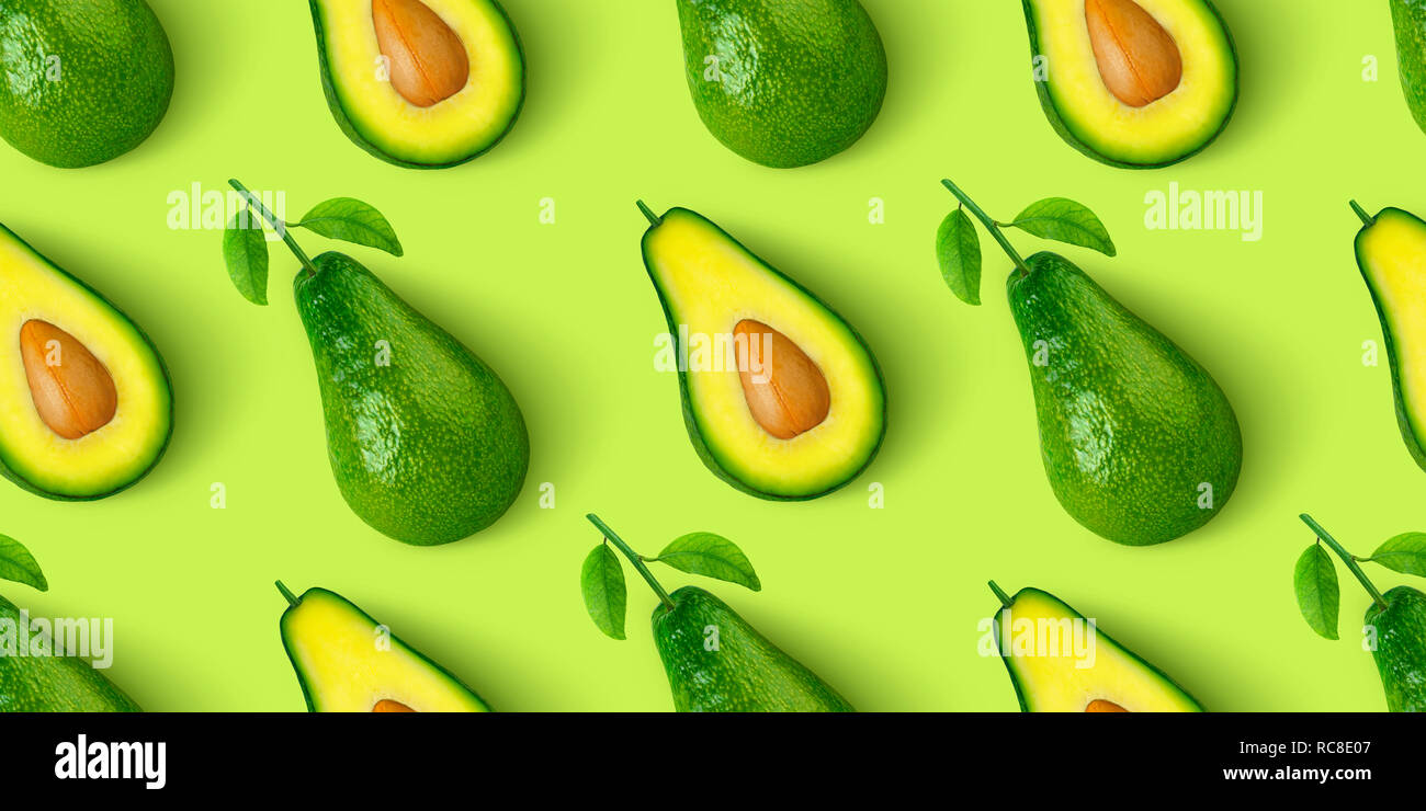 Avocado seamless pattern isolated on green background Stock Photo