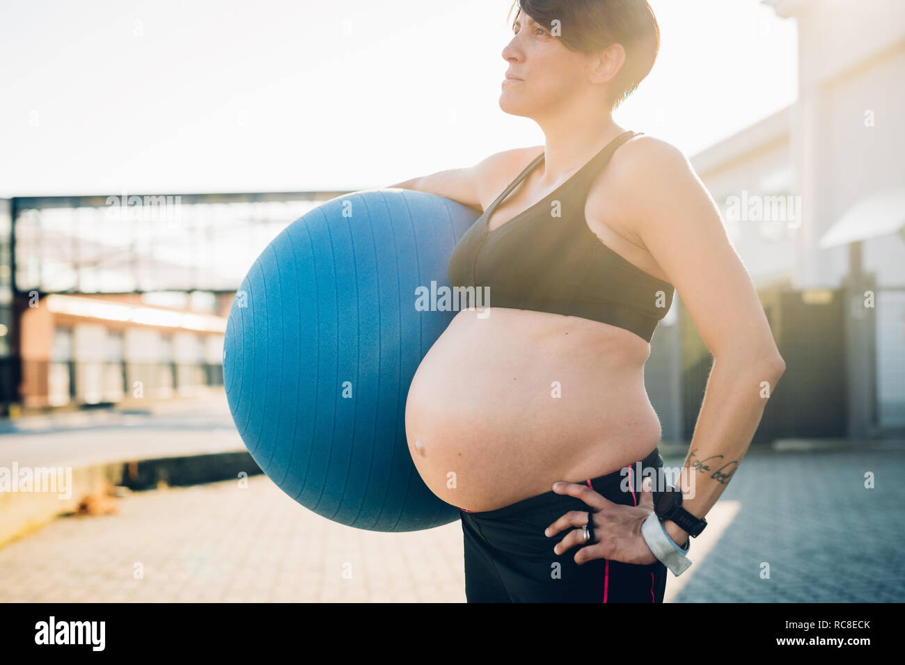 Pregnant woman holding exercise ball Stock Photo