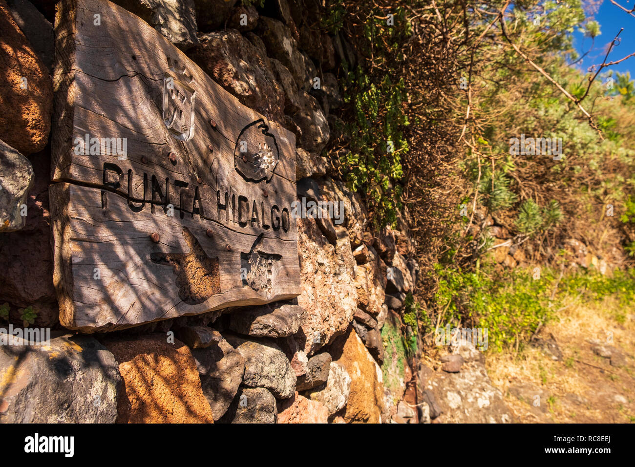Old carved wooden direction sign on the walking route to Punta Hidalgo from El Batan, Anaga, Tenerife, Canary Islands, Spain Stock Photo