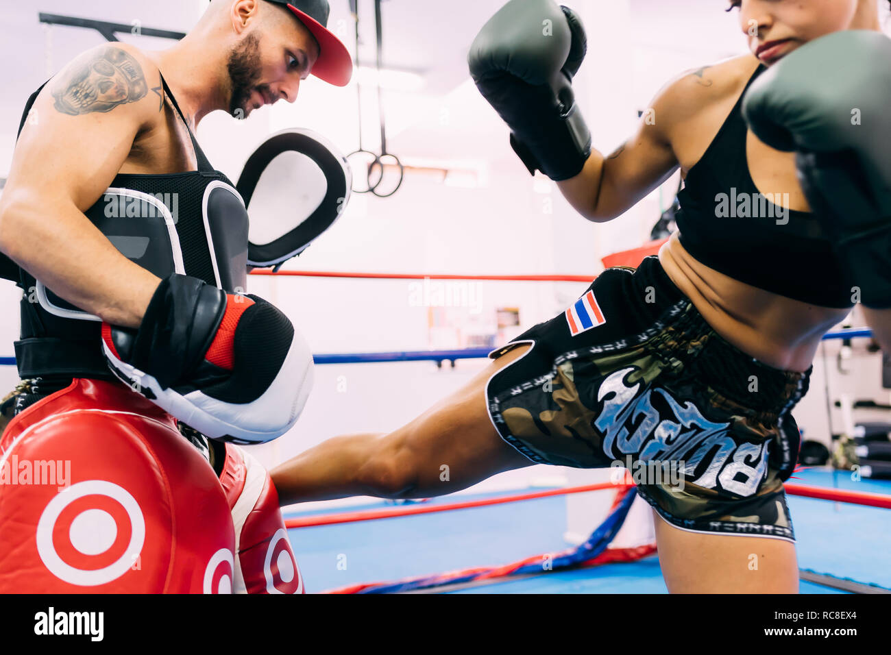 Male and female boxers working out in boxing ring Stock Photo