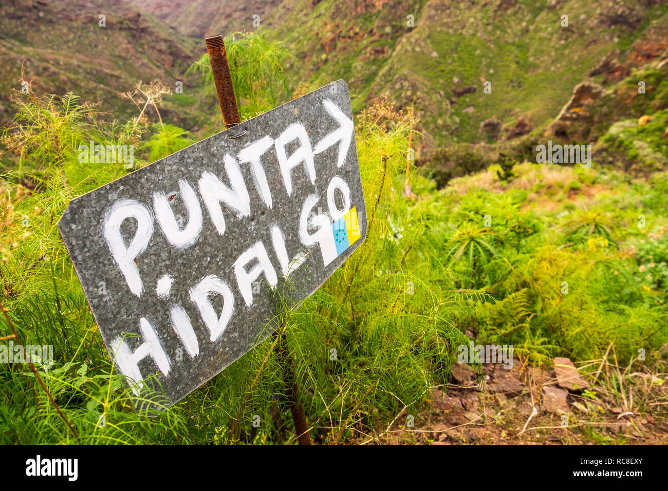 Hand painted metal sign indicating the direction of the walking route to Punta Hidalgo from El Batan, Anaga, Tenerife, Canary Islands, Spain Stock Photo