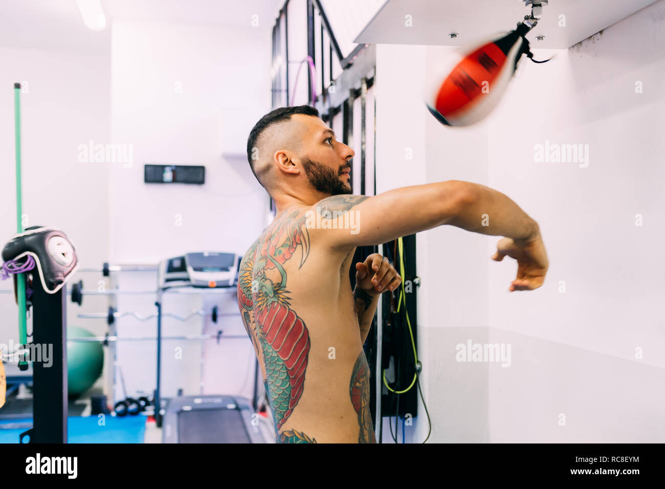 Man using punch bag in gym Stock Photo