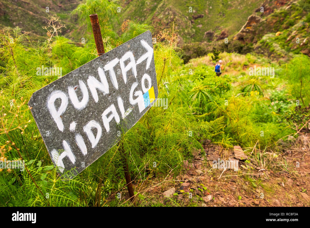 Hand painted metal sign indicating the direction of the walking route to Punta Hidalgo from El Batan, Anaga, Tenerife, Canary Islands, Spain Stock Photo