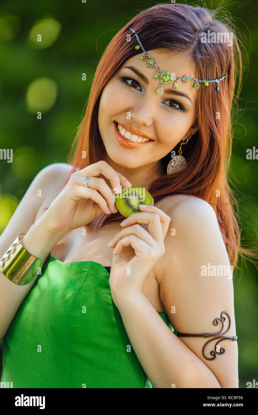 Portrait of a beautiful young asian woman in green dress and diadema on ...