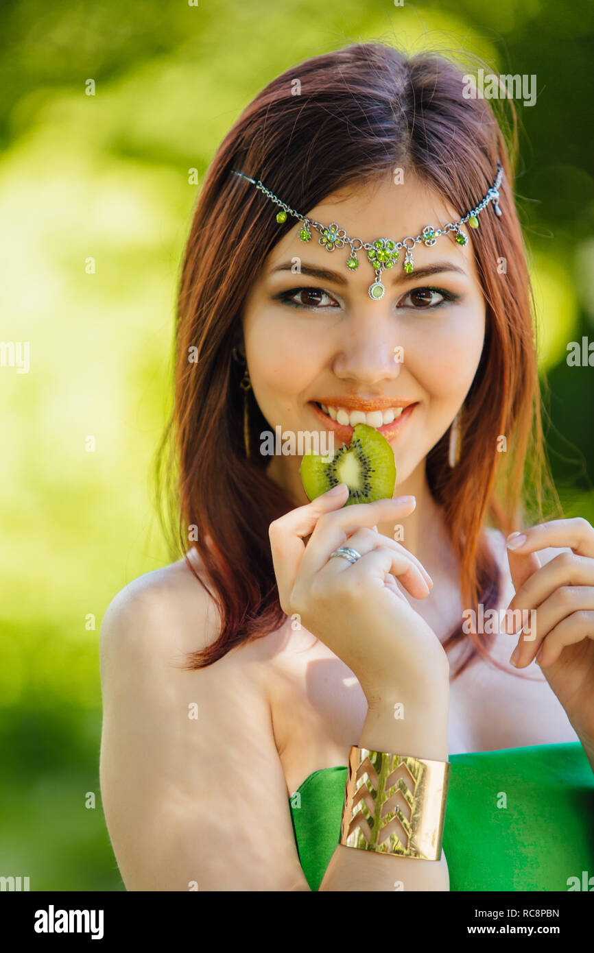 Portrait of a beautiful young asian woman in green dress and diadema on ...