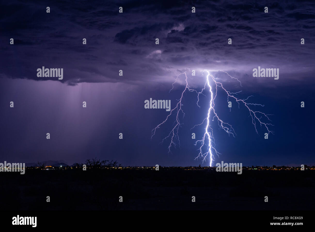 Powerful lightning bolt strikes from a summer monsoon storm over Casa Grande, Arizona Stock Photo