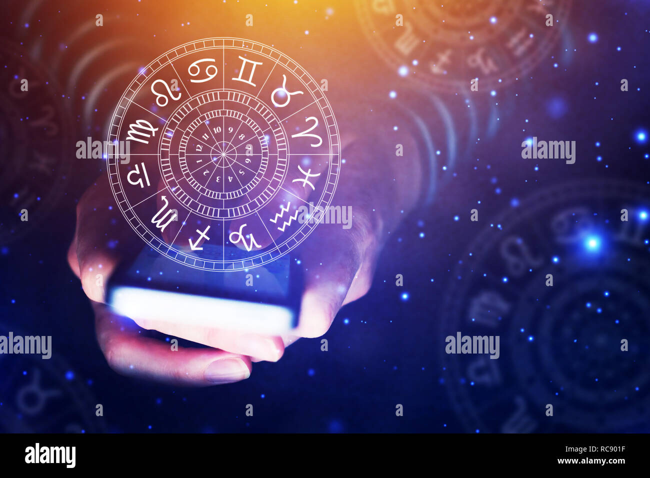 Astrology smartphone app concept, woman using mobile phone, close up of hands Stock Photo