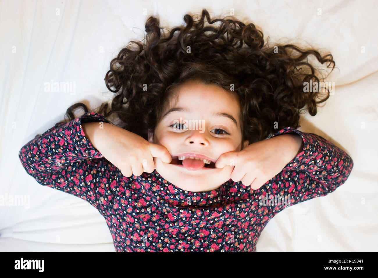 Curly haired girl makes goofy face Stock Photo