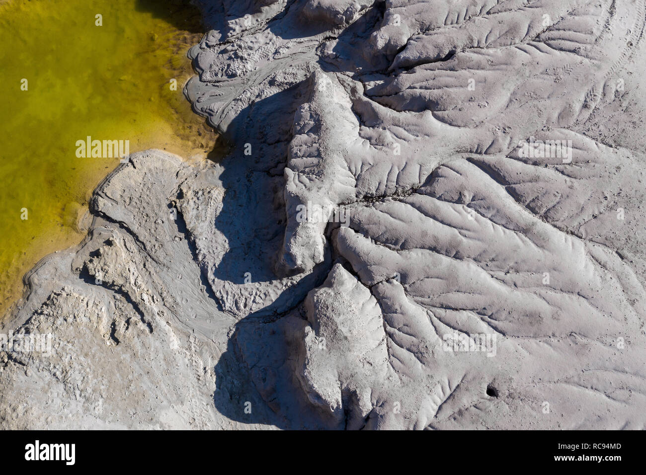 Aerial shot of abandoned opencast mine and waste lake. Abstract cracked ...