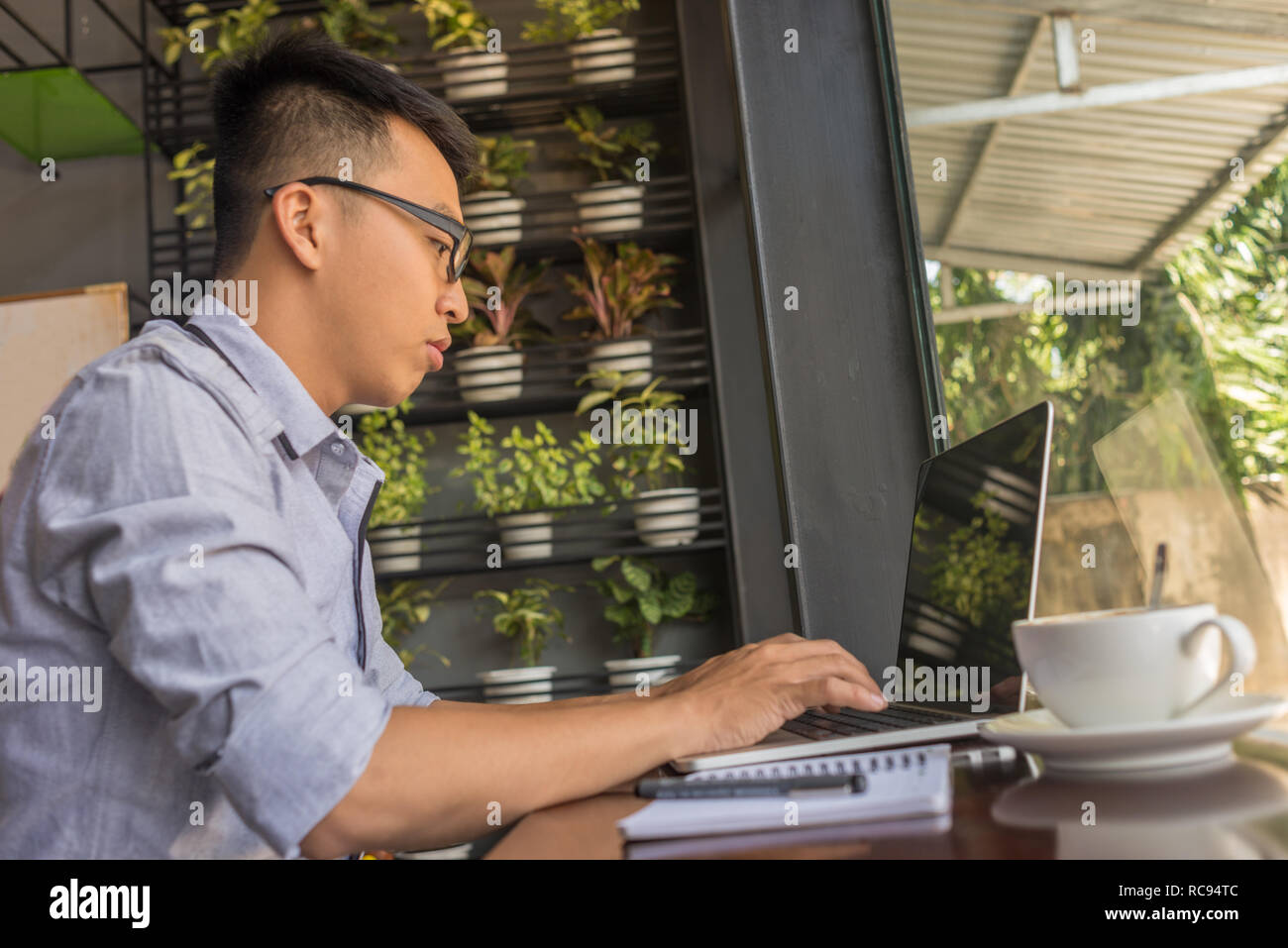 Young man studying on laptop Stock Photo