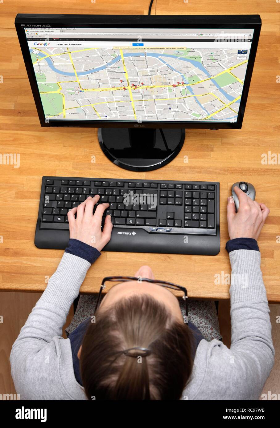 Woman surfing the internet with a computer, web search, Google Maps ...