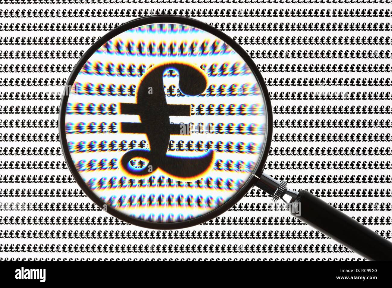 Pound symbol, currency symbol of the British pound, through a magnifying glass Stock Photo