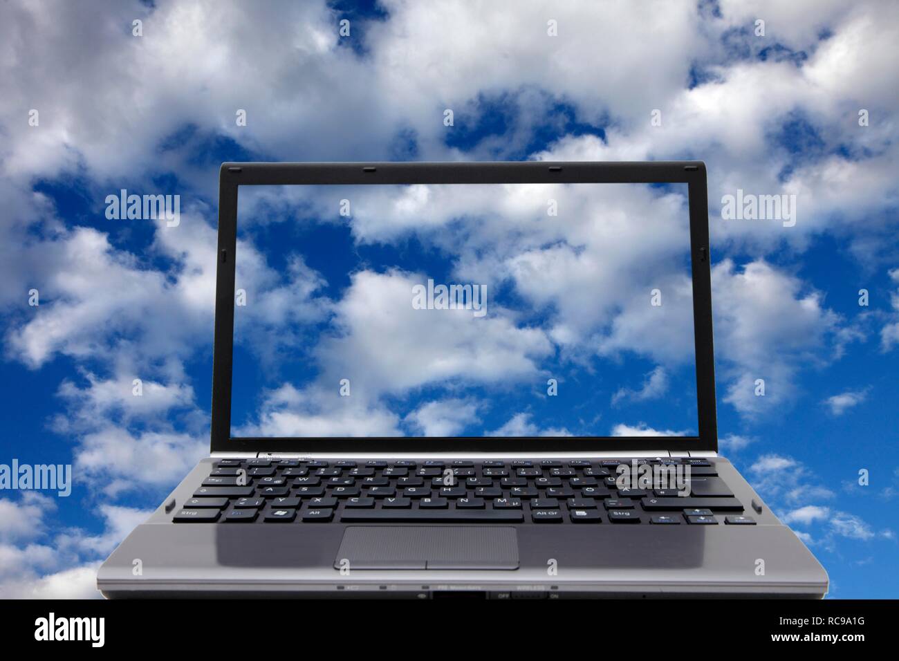 Laptop, clouds, sky, symbolic image for cloud computing, cloud Stock Photo
