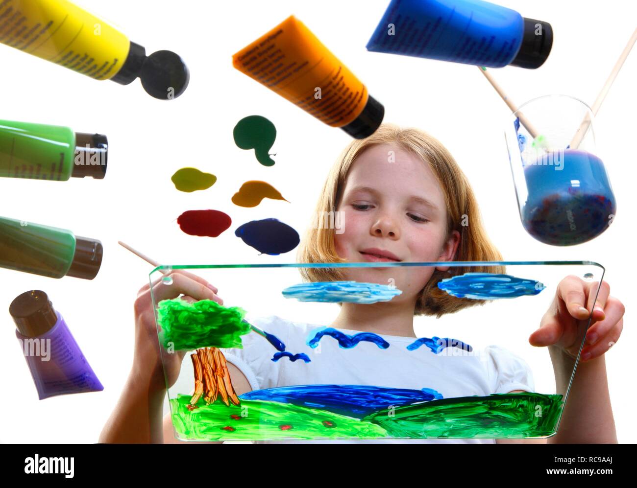 Girl, 11, painting a picture with acrylic colours Stock Photo