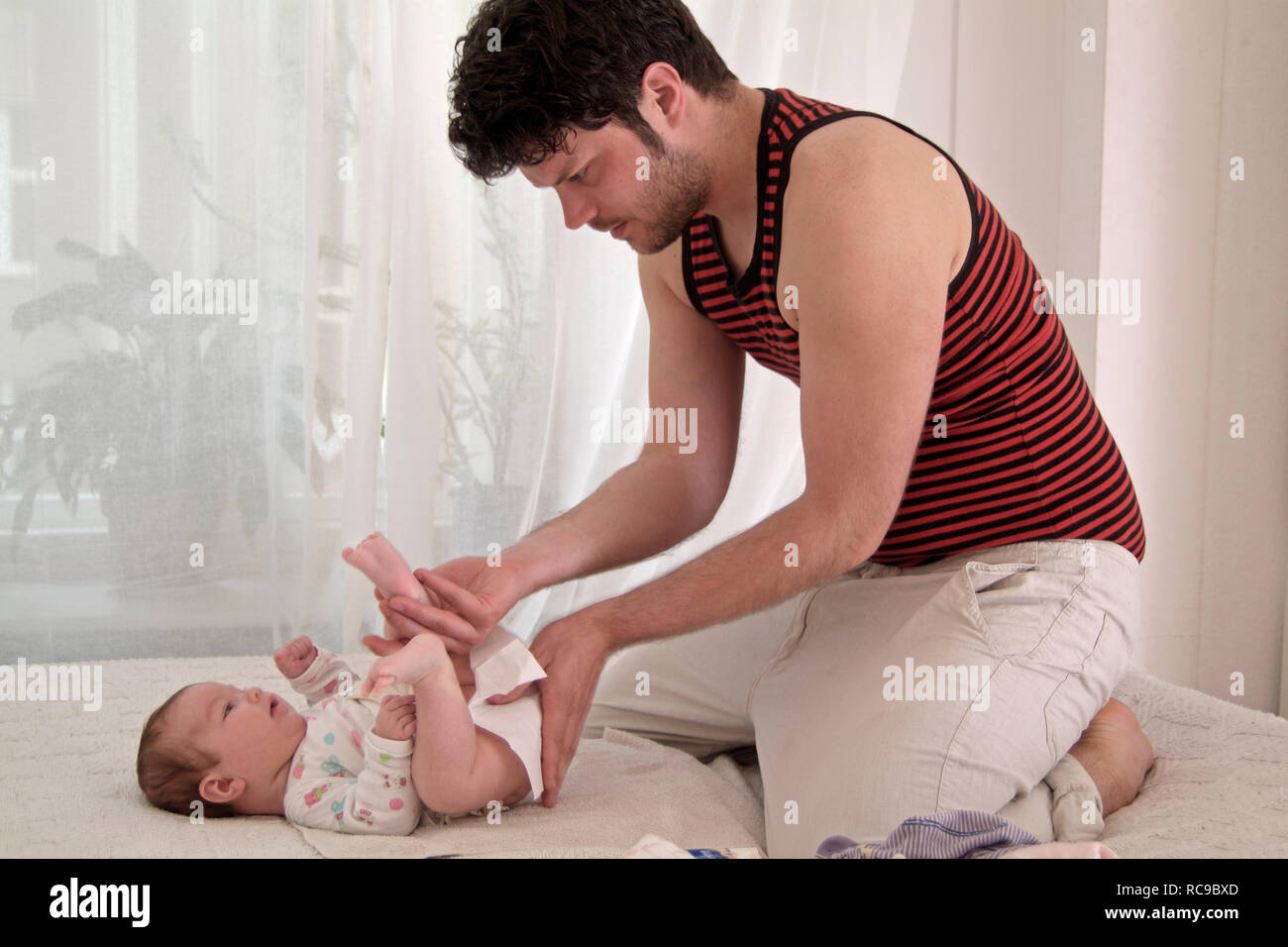 junger Vater wickelt Baby Stock Photo