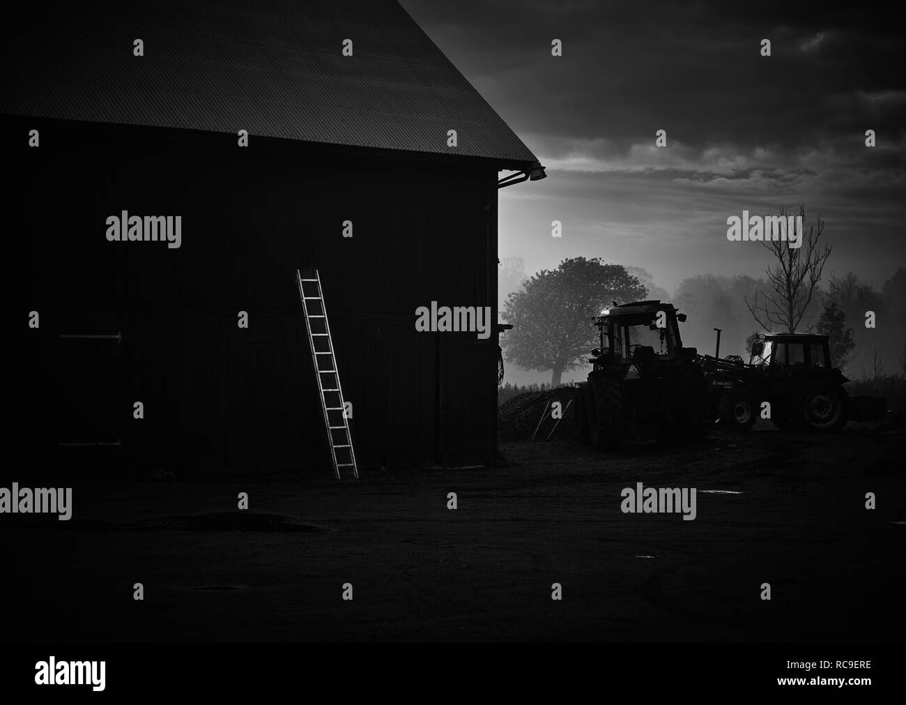 Barn and tractor at sunrise Stock Photo - Alamy