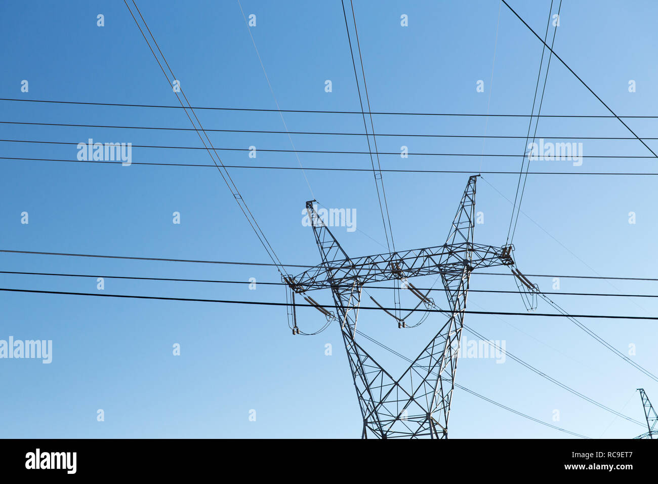 transmission tower and power line over blue sky Stock Photo - Alamy